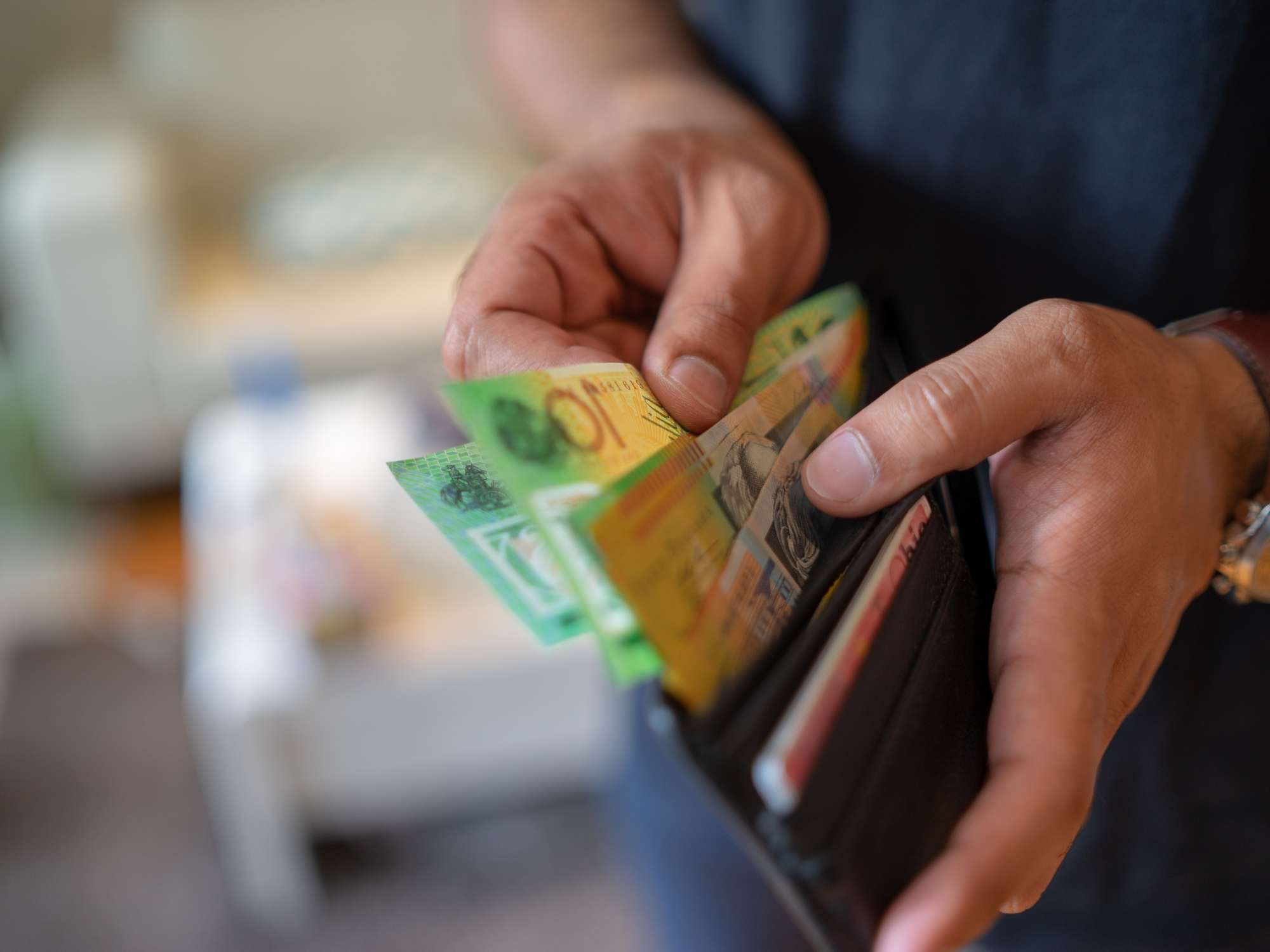 Australian dollar bills in brown wallet